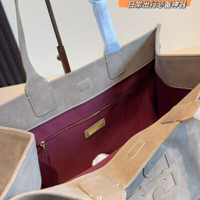 Tory Burch Ella tote bag in taupe suede with signature double T round logo on the front, top handle and carrying shoulders